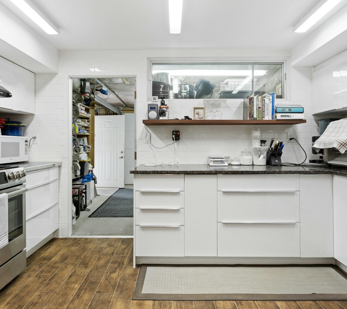 a kitchen with white cabinets and stainless steel appliances